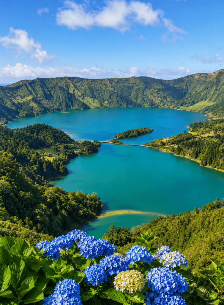Scenic view of Serra da Estrela Lake surrounded by lush green mountains.